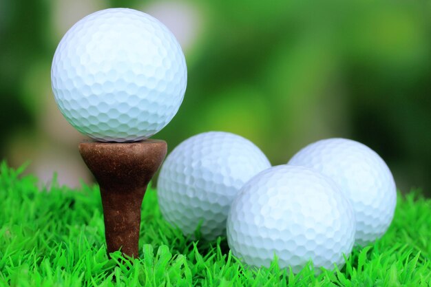 Golf balls on grass outdoor close up