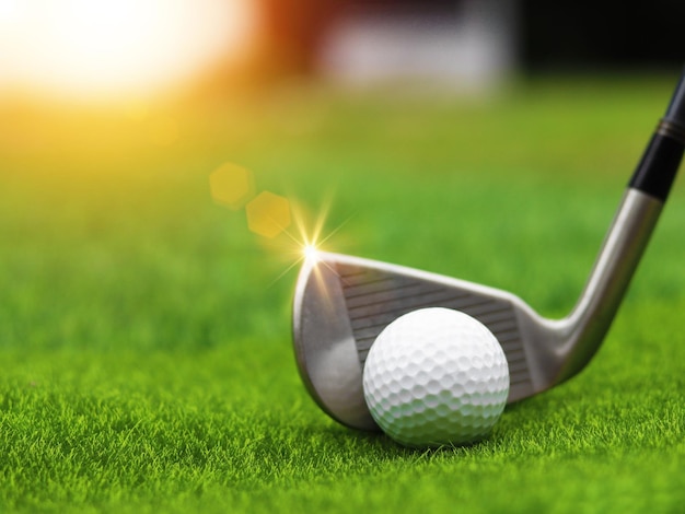 Golf club close up on green grass on blurred beautiful\
landscape of golf backgroundconcept international sport that rely\
on precision skills for health relaxationx9