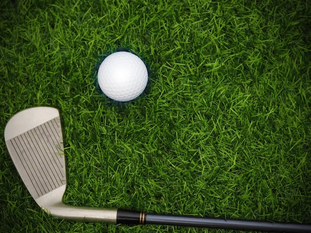 Golf club top view on green grass on blurred beautiful\
landscape of golf backgroundconcept international sport that rely\
on precision skills for health relaxationx9