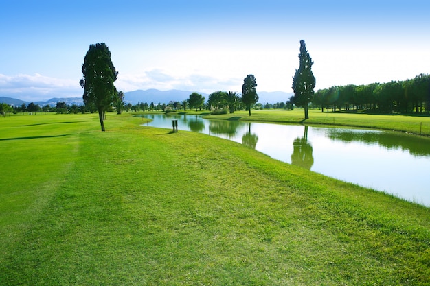 Golf course green grass field lake reflection