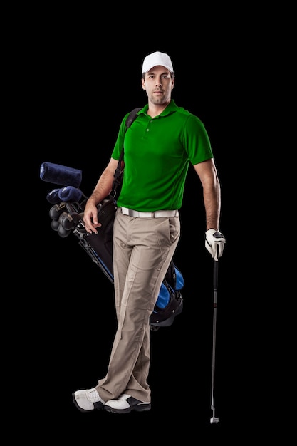 Golf Player in a green shirt, standing with a bag of golf clubs on his back, on a Black Background.