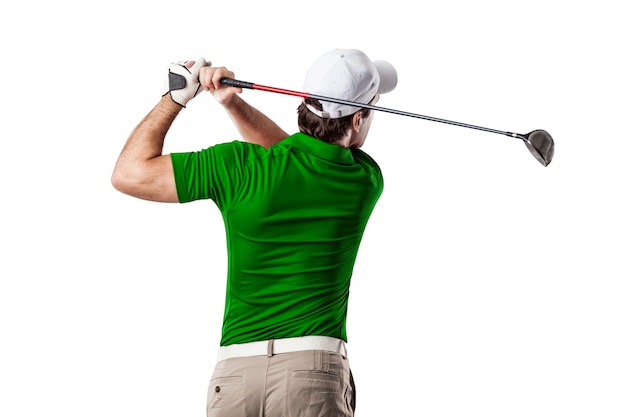 Photo golf player in a green shirt taking a swing, on a white background.