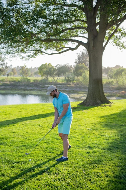 Golf player playing golf on sunny day Golfer taking shot on golf course