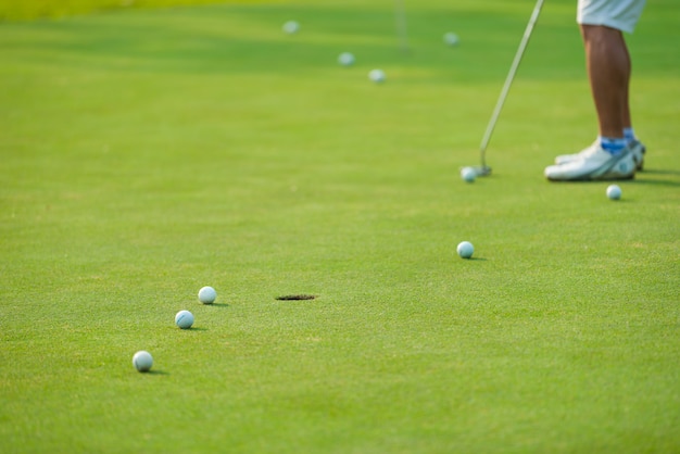 Golf player putting golf ball