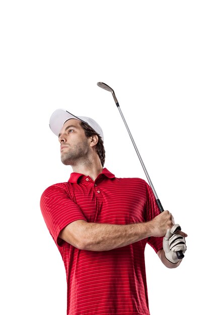 Golf Player in a red shirt taking a swing, on a white space.