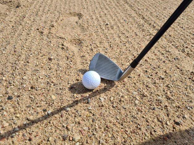 Golf shot from sand bunker golfer hitting ball from danger Sand golf course