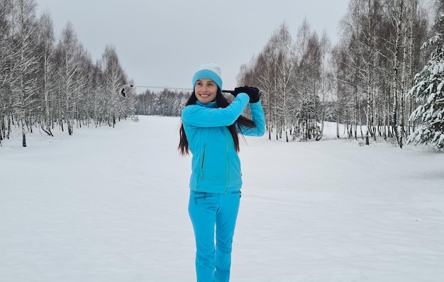 Golf in the snow with a ball golfer with a club Smiling female golfer playing golf in winter