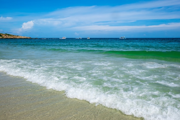 Golf van groene oceaan aan zandstrand en de blauwe hemel