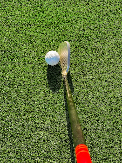 Golfclub en golfbal close-up in grasveld