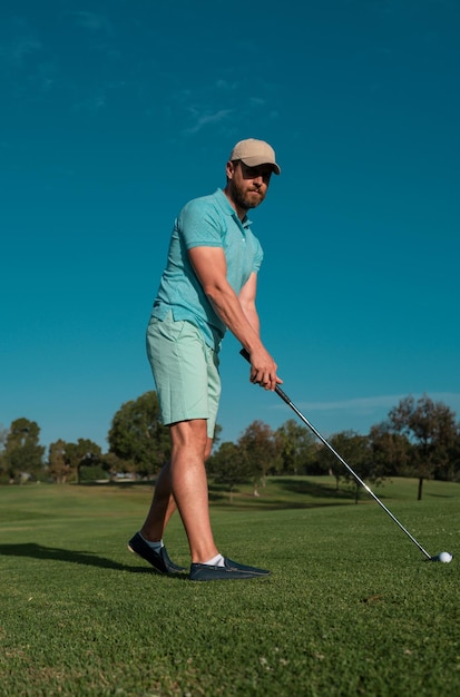 Golfer man playing golf on beautiful sunny green golf course