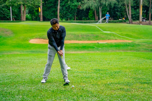 Golfer raakt golfbal op tee-off zone van de golfbaan