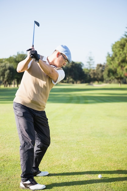 Golfer raising his golf club