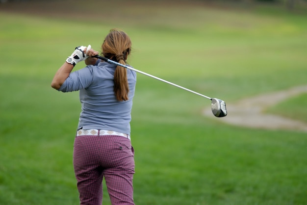 Golfer shooting a golf ball