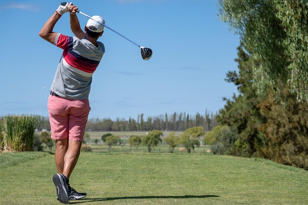 Golfer shooting a golf ball