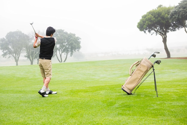 Golfer teeing off