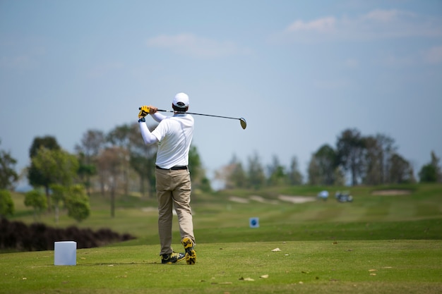 Golfers hit sweeping golf course in the summer