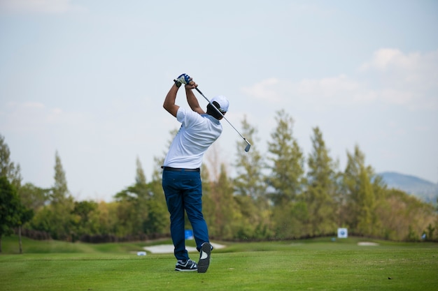 Golfers hit sweeping golf course in the summer