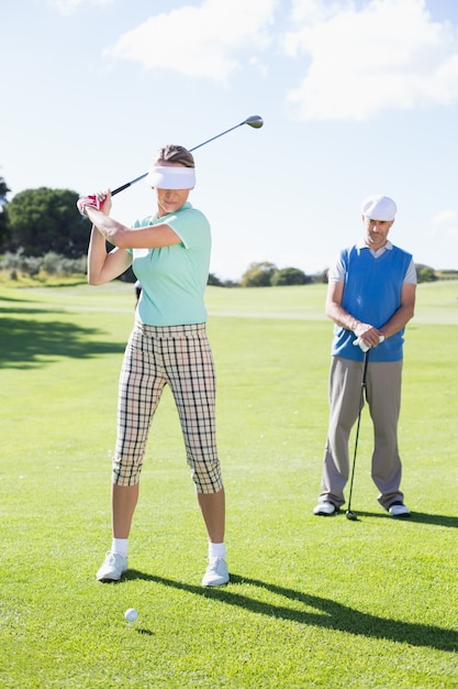 Golfing couple teeing off for the day