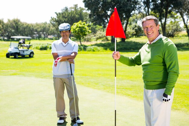 Golfing friends smiling at camera 