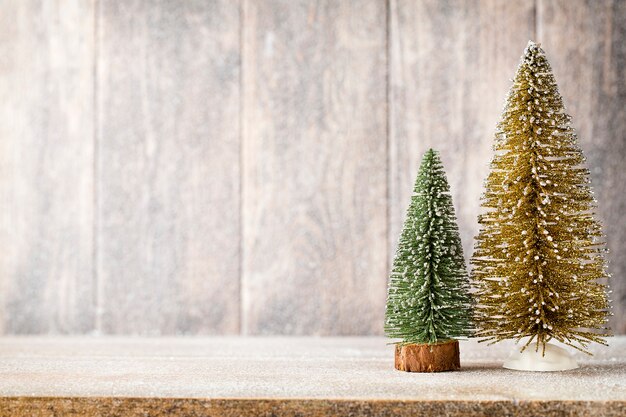 Golg and green christmas tree on a wooden background.