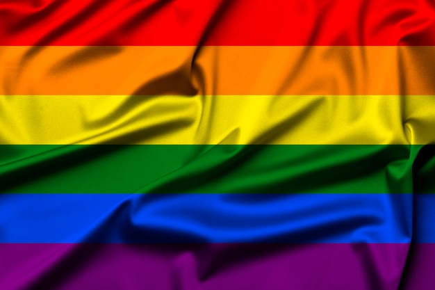 Golvende LGBTQI- of LGBT-vlag als heldere regenboogachtergrond. Gay Pride-symbool.