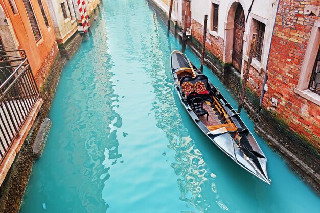 Gondola in a Venice green canal