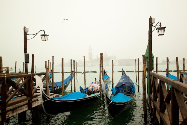 Gondolas on the canals of Venice on winter misty day, Venice, Italy