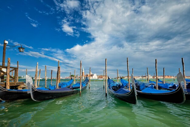 Gondolas and in lagoon of Venice by San Marco square Venice Italy