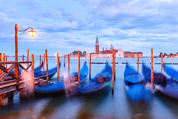 Gondolas at twilight in Venice lagoon Italia