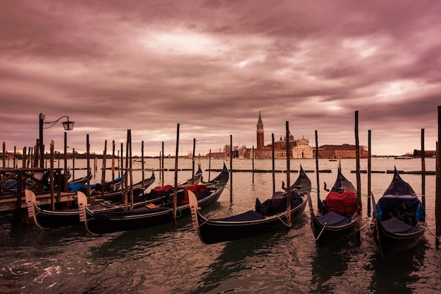 Gondolas in Venice on sunset next to San Marco square Famous landmark in Italy