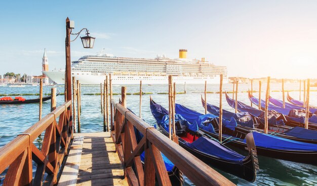 Gondolas in Venice - sunset with San Giorgio Maggiore church. Venice, Italy