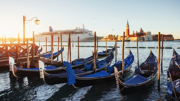 Gondolas in Venice - sunset with San Giorgio Maggiore church. Venice, Italy