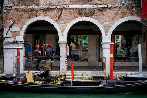 Foto gondolieri in attesa accanto alle loro gondole