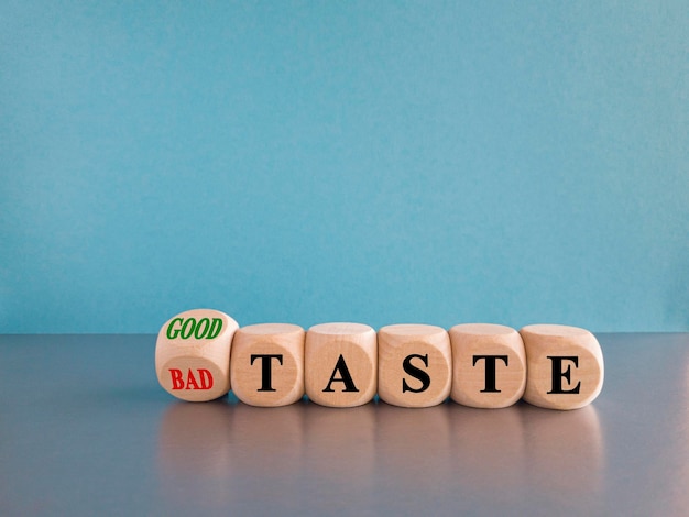 Good or bad taste symbol Turned a wooden cube and changes red words bad taste to good taste