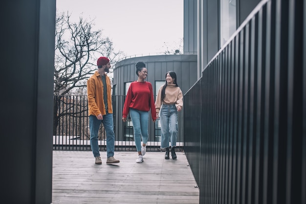 Good friends. Three friends walking together and feeling good