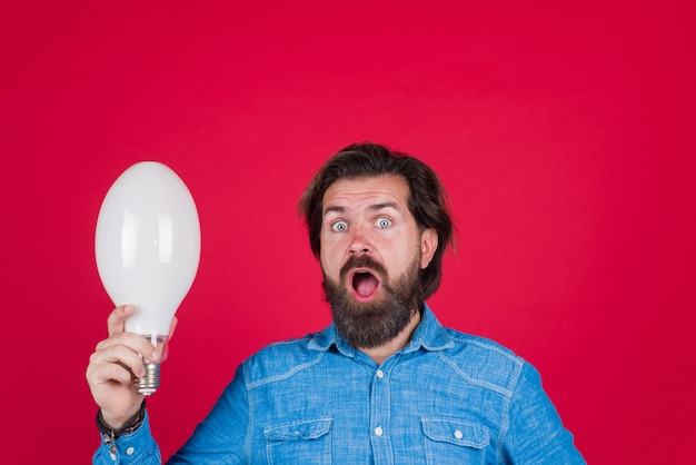 Good idea idea lamp in hand surprised man with big lamp thoughts idea concept bearded man holds