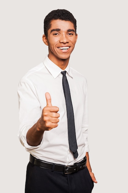 Good job! Confident young Afro-American man in formalwear stretching out hand with thumb up