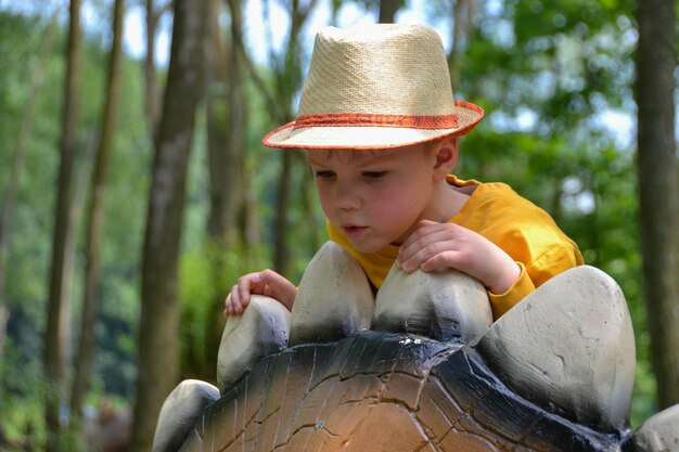 Good leisure for a child Teaching a child through play A handsome boy 3 oldl in a yellow jacket excavates the remains of dinosaurs High quality photo