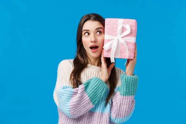 Good-looking female in sweater showing gesture.