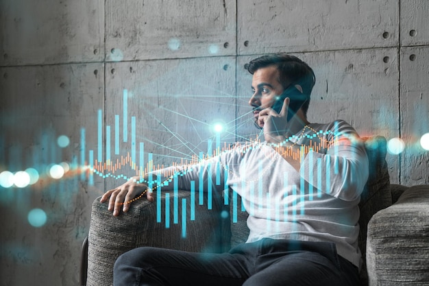 Good looking man in casual wears talking phone global financial market issue Double exposure The concept of Stock exchange trading Forex graph hologram