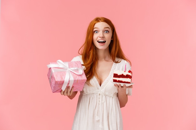 Good-looking redhead female in white dress showing gesture.