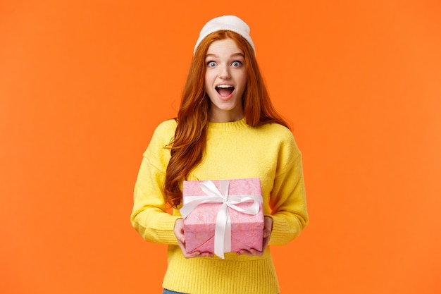 Good-looking redhead female in yellow sweater