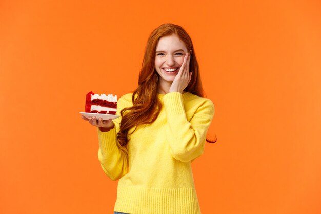Good-looking redhead female in yellow sweater