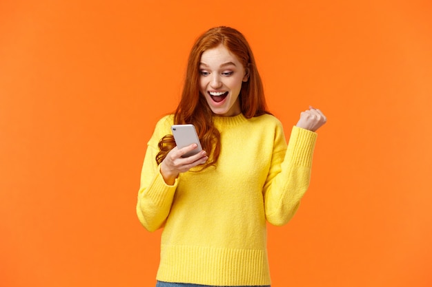 Good-looking redhead female in yellow sweater