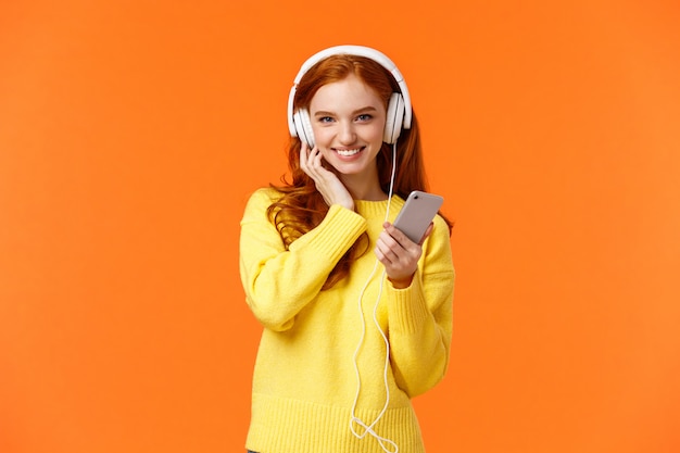 Good-looking redhead female in yellow sweater