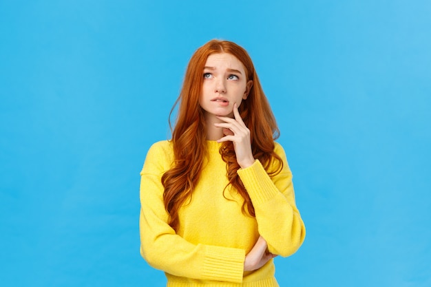 Good-looking redhead female in yellow sweater