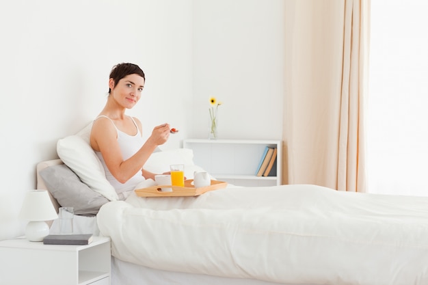 Bella donna che mangia la prima colazione