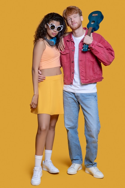 Good-looking young couple standing in the studio