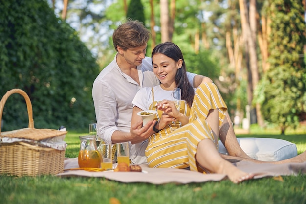 good looking young people in white and yellow clothing spending time in the green park