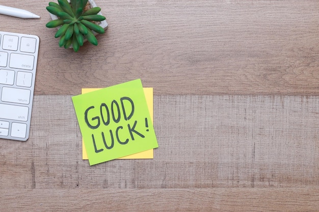 Photo good luck text on sticky notes with copy space over wooden background